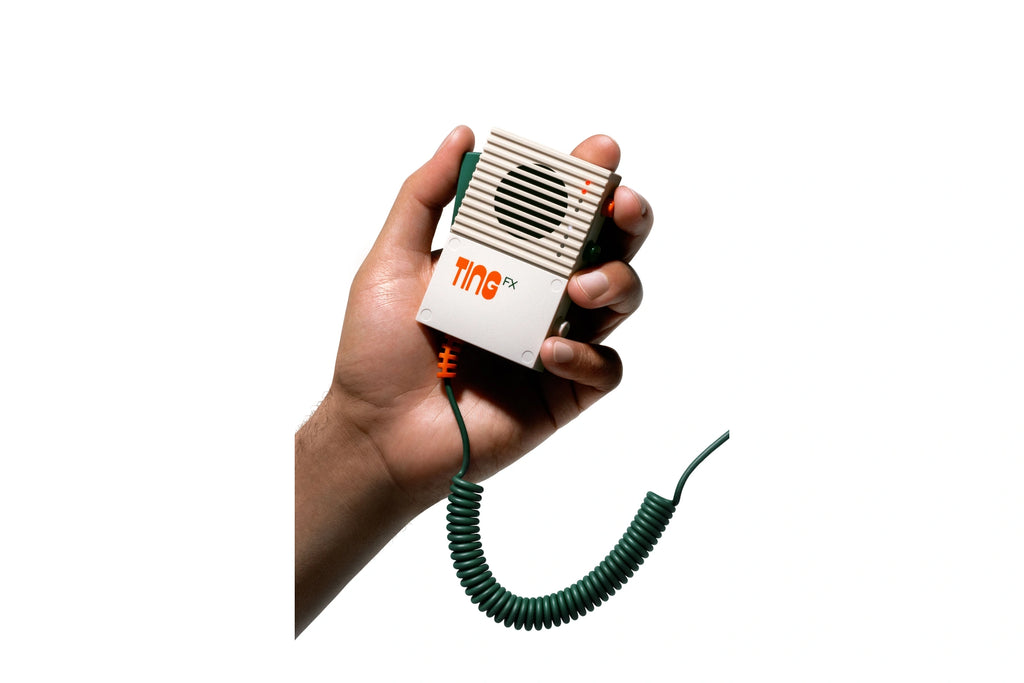 Original Teenage Engineering EP-2350 TING microphone in hand, cream grille, green lever and green curly cable